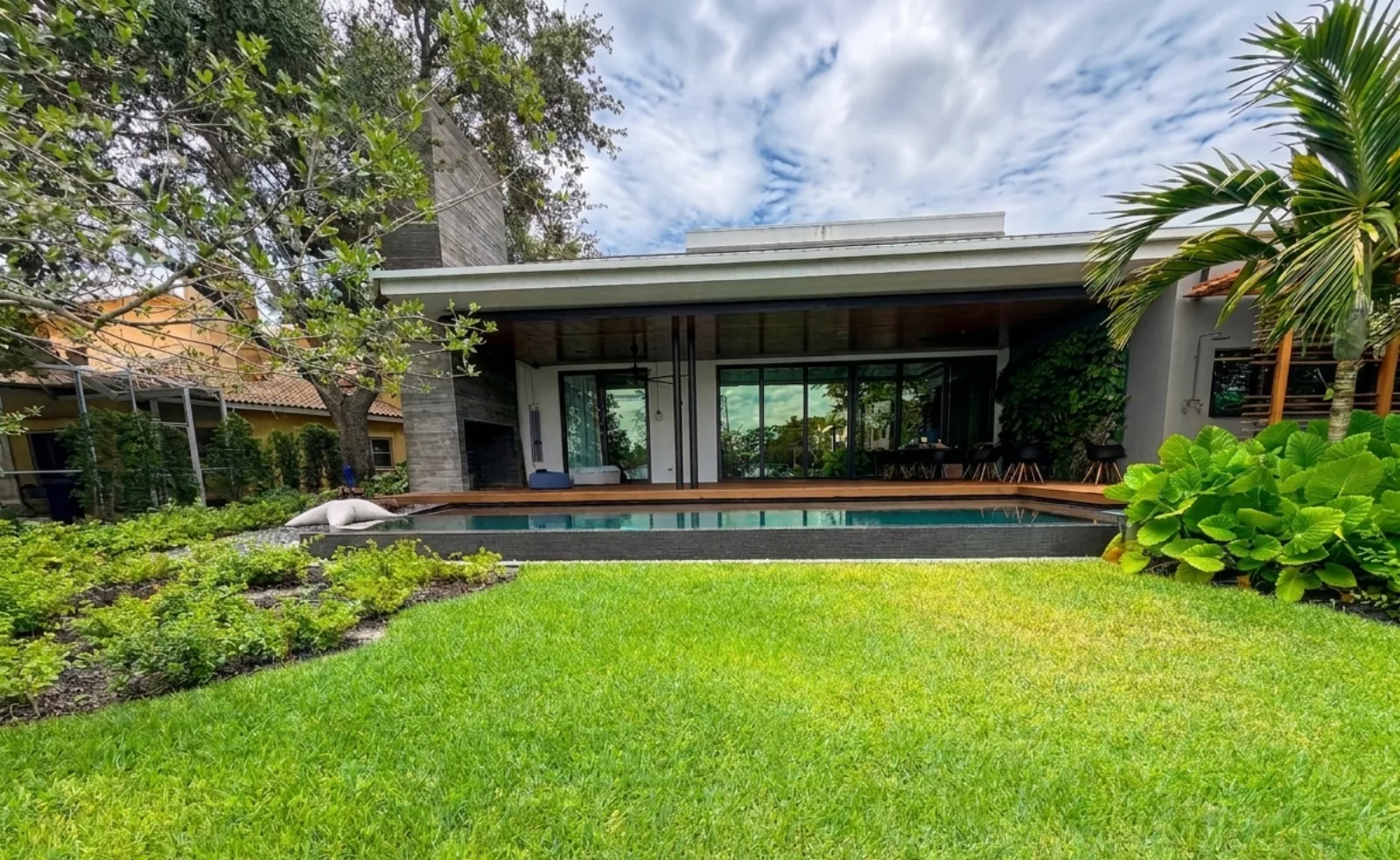 Modern home with a dark mosaic infinity-edge pool | FDS Pools
