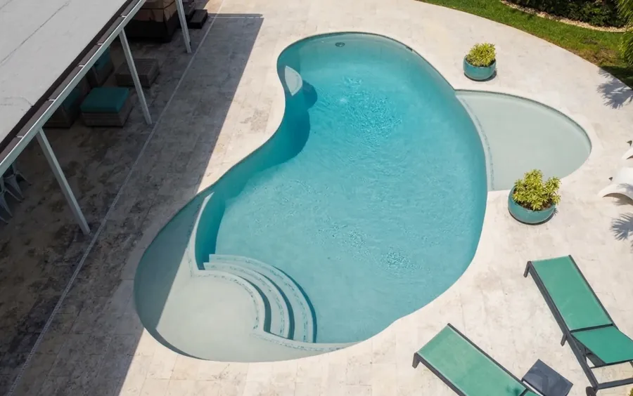 Freeform pool with tanning ledge, seen from above | FDS Pools